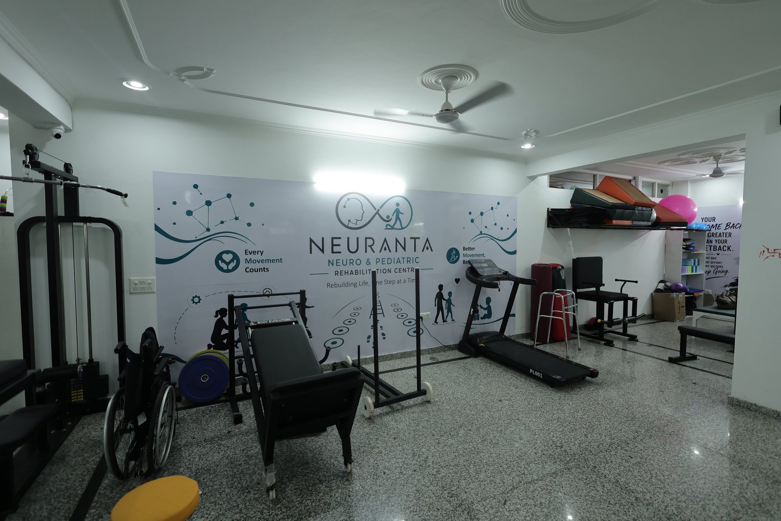 Neuro rehabilitation gym at Neuranta, Sector 39 Gurugram, with a treadmill, multi-station gym, wheelchair and branded wall